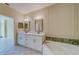 Spacious bathroom with double vanity, soaking tub, and separate shower at 2741 Via Cipriani # 930A, Clearwater, FL 33764
