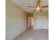 Bedroom with ceiling fan, tile floors, and access to hallway at 2741 Via Cipriani # 930A, Clearwater, FL 33764