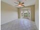 Bright bedroom with bay window, ceiling fan, and tile floors at 2741 Via Cipriani # 930A, Clearwater, FL 33764