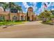 Inviting community building exterior with palm trees at 2741 Via Cipriani # 930A, Clearwater, FL 33764