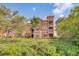 Three-story building with balconies and lush landscaping at 2741 Via Cipriani # 930A, Clearwater, FL 33764