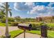 Community grilling area with pathway and landscaping at 2741 Via Cipriani # 930A, Clearwater, FL 33764