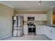 Modern kitchen featuring stainless steel appliances and white cabinetry at 2741 Via Cipriani # 930A, Clearwater, FL 33764
