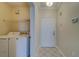 Laundry room with washer, dryer, and shelving at 2741 Via Cipriani # 930A, Clearwater, FL 33764