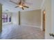 Bright living room with tiled floors, ceiling fan and access to bathroom at 2741 Via Cipriani # 930A, Clearwater, FL 33764