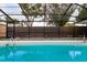 Inviting screened pool with surrounding landscaping at 3524 Emory Dr, Holiday, FL 34691