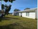 Large grassy backyard with white building exterior at 3562 90Th N Ter, Pinellas Park, FL 33782