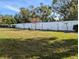 Backyard with grassy lawn and white wall at 3562 90Th N Ter, Pinellas Park, FL 33782