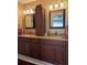 Double vanity bathroom with granite countertops and dark wood cabinets at 3562 90Th N Ter, Pinellas Park, FL 33782