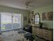 Bedroom with floral bedding and dresser at 3562 90Th N Ter, Pinellas Park, FL 33782