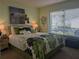Bedroom with floral bedding and large window at 3562 90Th N Ter, Pinellas Park, FL 33782