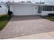 Brick driveway and garage of a single-story home at 3562 90Th N Ter, Pinellas Park, FL 33782