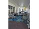 Relaxing front porch with wicker furniture and blue rug at 3562 90Th N Ter, Pinellas Park, FL 33782