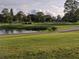 Golf course landscape with pond and walking path at 3562 90Th N Ter, Pinellas Park, FL 33782