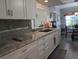 Modern kitchen with granite countertops and white cabinets at 3562 90Th N Ter, Pinellas Park, FL 33782