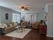 Living room with hardwood floors, comfy seating and large windows at 3562 90Th N Ter, Pinellas Park, FL 33782