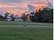 Empty lot with sunset view and distant homes at 3562 90Th N Ter, Pinellas Park, FL 33782