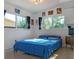 Well-lit bedroom with large windows and blue bedding at 407 Courtney Dr, Temple Terrace, FL 33617