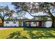 Mid-century modern home with a carport and landscaped yard at 407 Courtney Dr, Temple Terrace, FL 33617