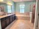 Spa-like bathroom with double vanity, large shower, and garden tub at 5011 Jagged Cloud Dr, Wimauma, FL 33598