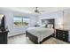 Bedroom with water view, ceiling fan, and dark dresser at 5200 Brittany S Dr # 1110, St Petersburg, FL 33715
