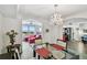 Elegant dining room with a chandelier and glass table at 5200 Brittany S Dr # 1110, St Petersburg, FL 33715