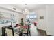 Bright dining room with glass table, chandelier, and water views at 5200 Brittany S Dr # 1110, St Petersburg, FL 33715