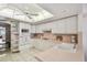 White kitchen with pink tile backsplash and stainless steel appliances at 5200 Brittany S Dr # 1110, St Petersburg, FL 33715