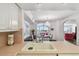 Kitchen with pink tile counters, white cabinets, and a view to dining area at 5200 Brittany S Dr # 1110, St Petersburg, FL 33715