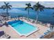 Community pool with water view and lounge chairs at 5200 Brittany S Dr # 1110, St Petersburg, FL 33715