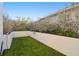 Small grassy backyard area with white walls at 5418 Wayfarer Ave, Apollo Beach, FL 33572
