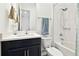 Clean bathroom with a dark vanity, shower, and bathtub at 5418 Wayfarer Ave, Apollo Beach, FL 33572