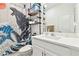 Clean bathroom with white vanity, toilet and shower with Godzilla themed curtain at 5418 Wayfarer Ave, Apollo Beach, FL 33572