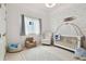 Charming Bedroom with a crib, chair, and playful decor at 5418 Wayfarer Ave, Apollo Beach, FL 33572