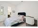 Bright bedroom with a comfy bed, built-in desk, and en-suite bathroom access at 5418 Wayfarer Ave, Apollo Beach, FL 33572