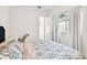 Light and airy bedroom featuring a floral bedspread and a workspace at 5418 Wayfarer Ave, Apollo Beach, FL 33572