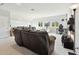 Versatile bonus room with seating, home gym equipment, and large windows at 5418 Wayfarer Ave, Apollo Beach, FL 33572