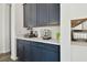 Built-in coffee bar with dark blue cabinets and quartz countertop at 5418 Wayfarer Ave, Apollo Beach, FL 33572