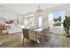 Spacious dining room with white table, rattan chairs, and chandelier at 5418 Wayfarer Ave, Apollo Beach, FL 33572