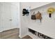 White entryway bench with shoe storage and coat hooks at 5418 Wayfarer Ave, Apollo Beach, FL 33572