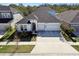 Two-story house with a three-car garage and landscaped yard at 5418 Wayfarer Ave, Apollo Beach, FL 33572
