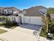 Two-story house with a three-car garage and well-manicured lawn at 5418 Wayfarer Ave, Apollo Beach, FL 33572