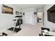 Home gym with treadmill, weight bench and large TV at 5418 Wayfarer Ave, Apollo Beach, FL 33572