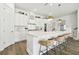 Modern kitchen with white cabinets, quartz counters, and gold accents at 5418 Wayfarer Ave, Apollo Beach, FL 33572
