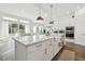 Open kitchen with white cabinets, island, and farmhouse sink at 5418 Wayfarer Ave, Apollo Beach, FL 33572
