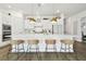 Modern kitchen with white cabinets, quartz countertops and island at 5418 Wayfarer Ave, Apollo Beach, FL 33572