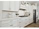 Modern kitchen with white cabinets and herringbone backsplash at 5418 Wayfarer Ave, Apollo Beach, FL 33572