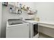 Bright laundry room, Samsung washer and dryer, and ample storage at 5418 Wayfarer Ave, Apollo Beach, FL 33572