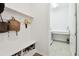 Bright laundry room with built-in shelving and bench at 5418 Wayfarer Ave, Apollo Beach, FL 33572