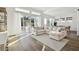 Bright living room with large sectional sofa and sliding glass doors leading to patio at 5418 Wayfarer Ave, Apollo Beach, FL 33572